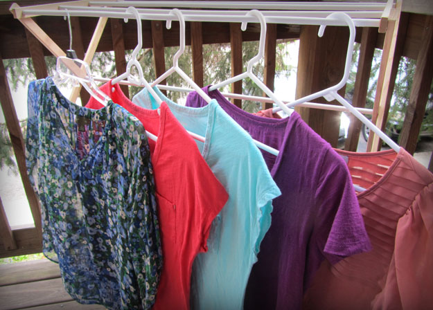 Photo of thrift store shirts hanging on clothes rack