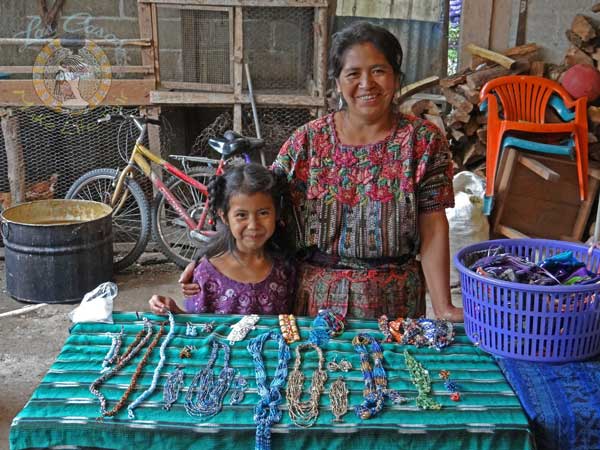 Guatemalan artisan with table of jewelry