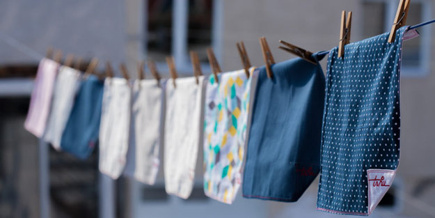 Several handkerchiefs hanging on an outdoor clothesline