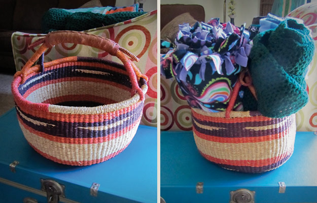 Basket with leather handles holding blankets