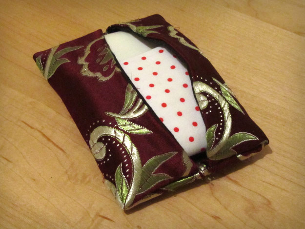 Two handkerchiefs folded in small satin case
