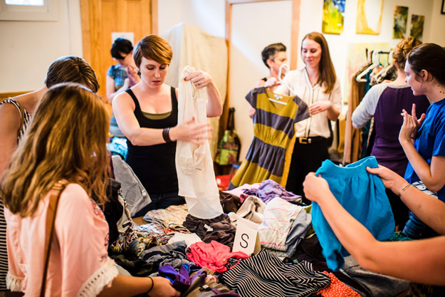 Swappers browse clothes on a table