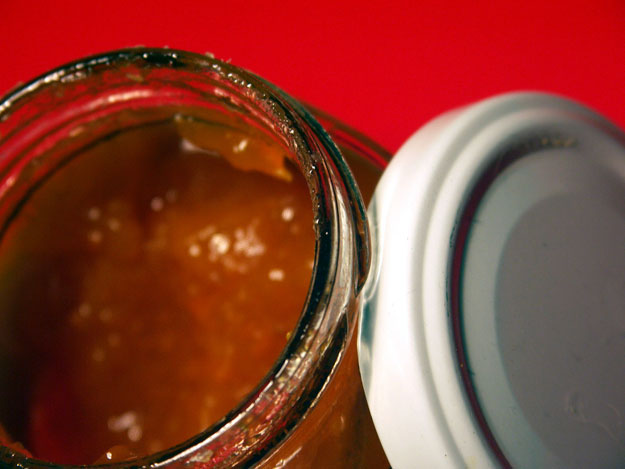 Close-up of jar of salsa and lid