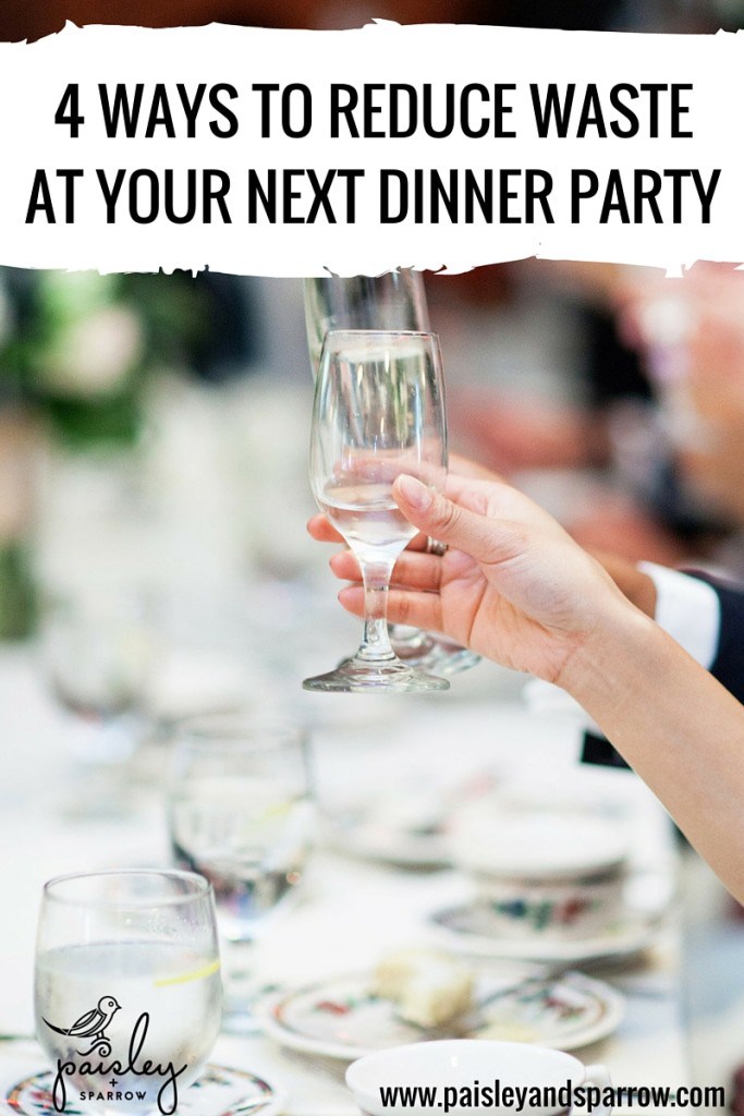 Woman raising glass at dinner party