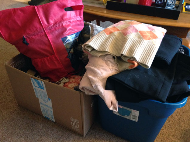 Two boxes overflowing with clothes